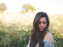 girl-thinking-in-a-field