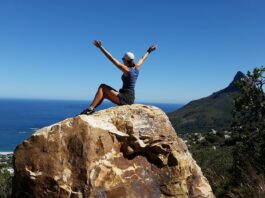 woman-celebrates-her-happy-life-on-a-rock-near-the-sea