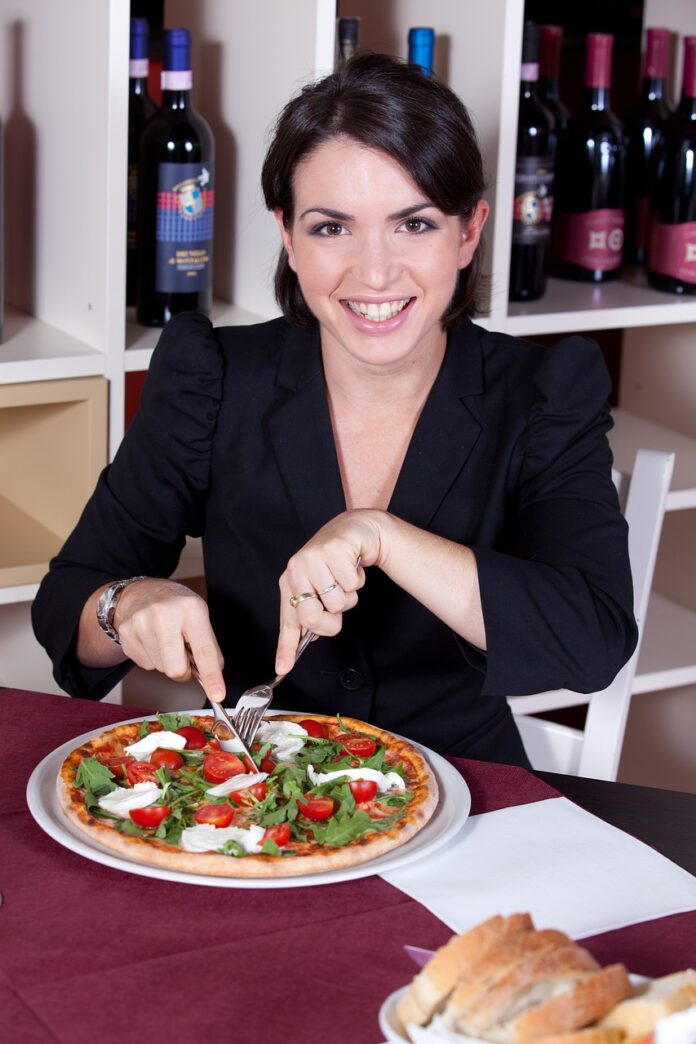 a-woman-with-dark-clothes-eating-a-healthy-meal