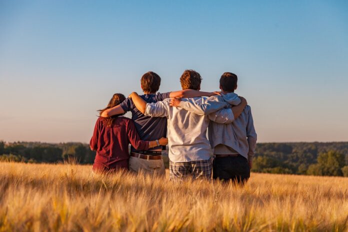 young-group-of-friends-in-a-field